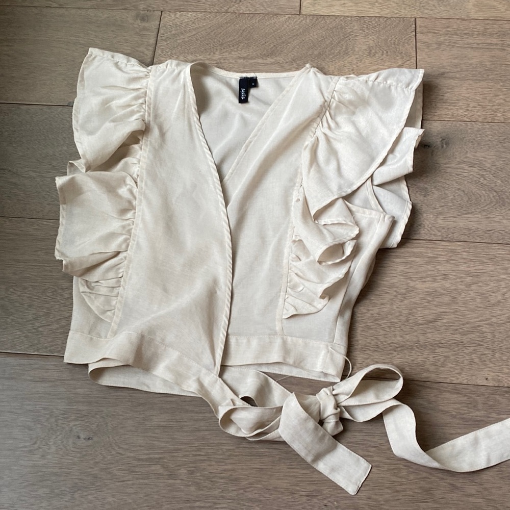 Light tan colored wrap top with sleeve detail